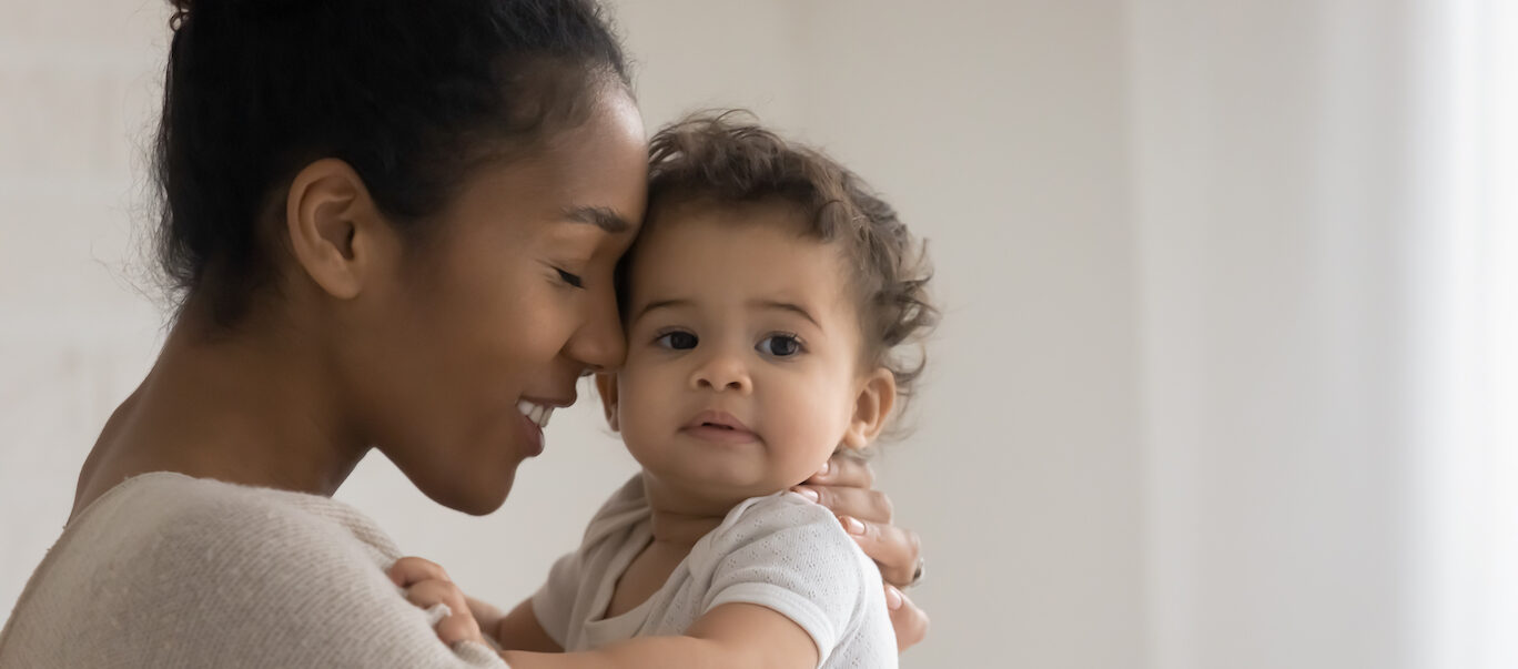 Black woman smiling with small child