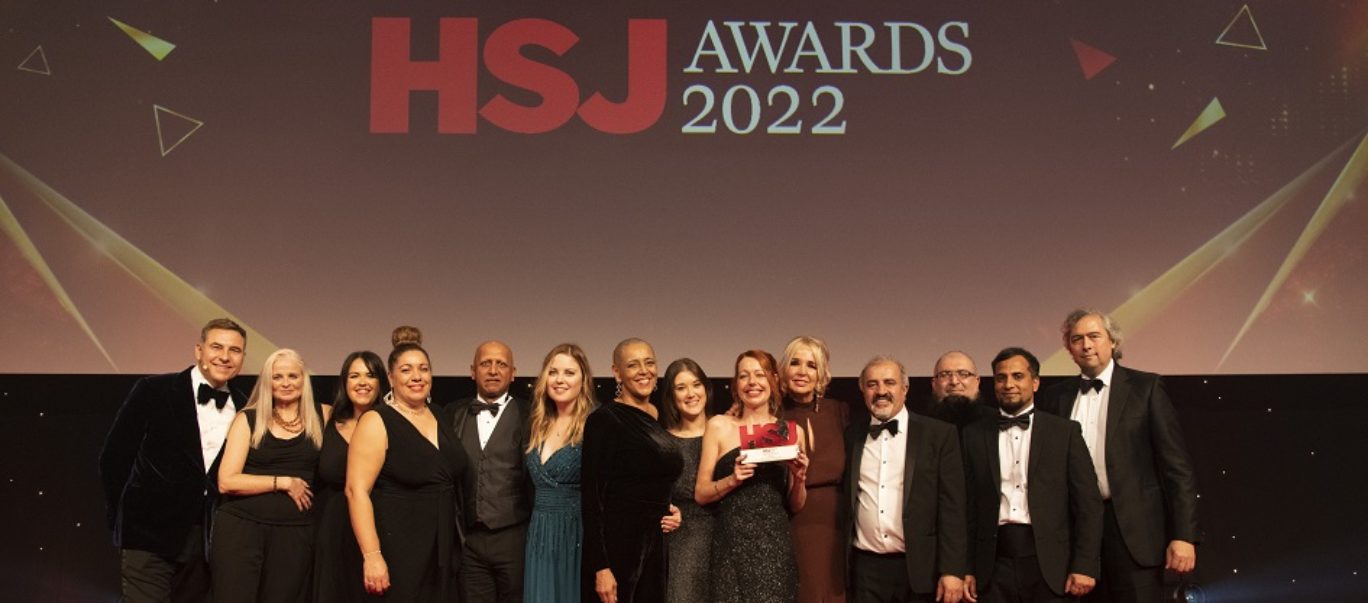 West Yorkshire Health and Care Partnership staff collecting an award on stage at the HSJ Awards 2022