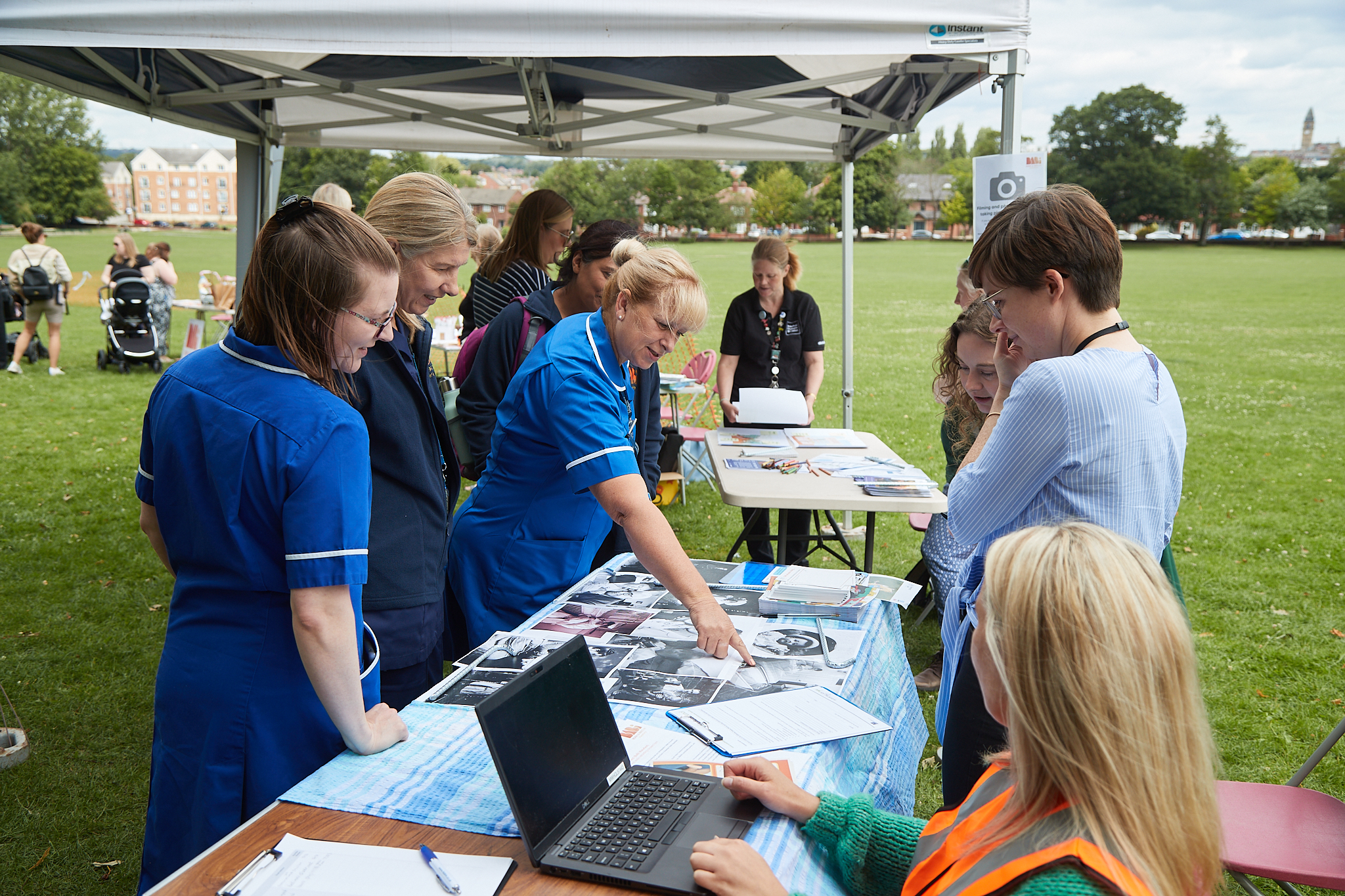 Image of midwives visiting the Wakefield museums stall at an event in a park.