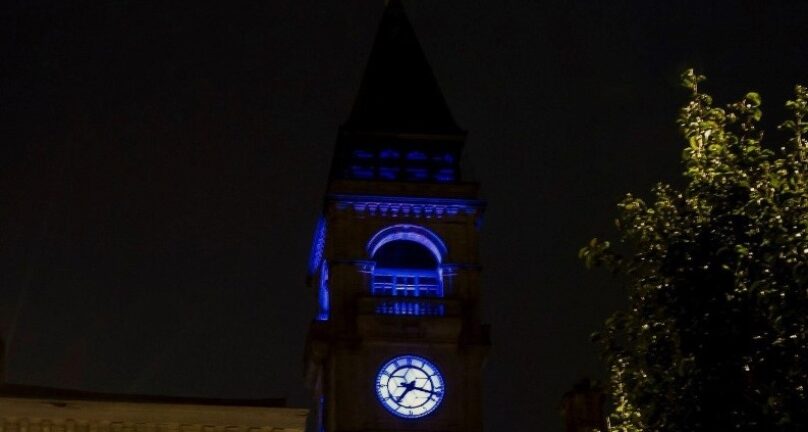 Wakefield Town Hall clock tower lit up blue
