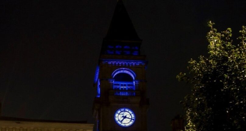 Wakefield Town Hall clock tower lit up blue