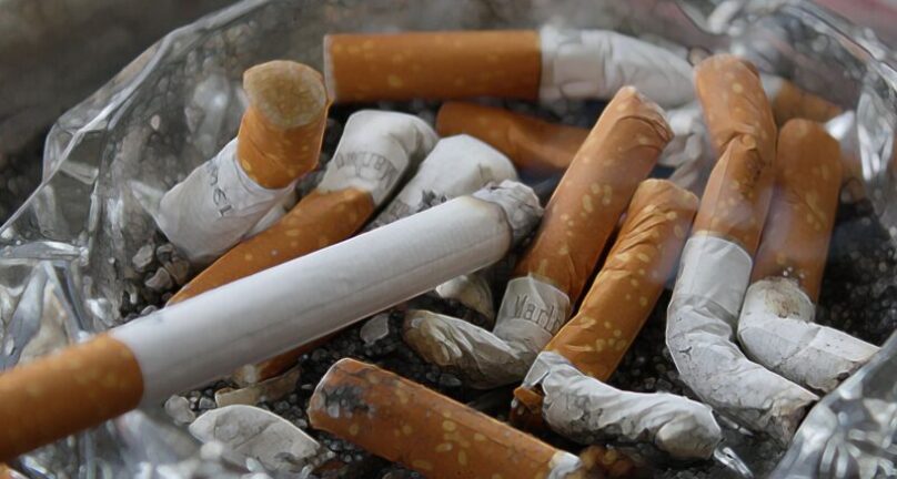 Smoked cigarettes grouped together in an ashtray