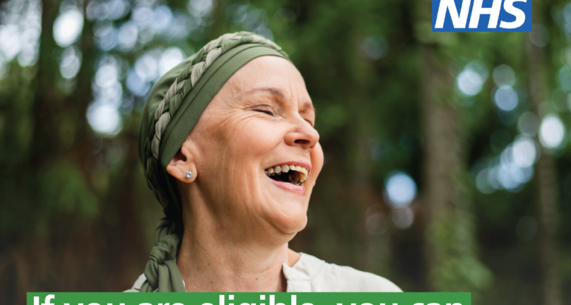 A woman wearing a head scarf smiles with her eyes closed. Text in image reads; if you are eligible, you can book your spring COVID-19 vaccination online or via the NHS App.