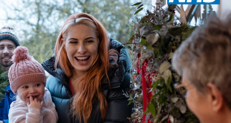 NHS logo Protect your festive season with a flu vaccine Don't let flu ruin your fun. Image of a lady and a small child being greeted at a front door during the festive season.
